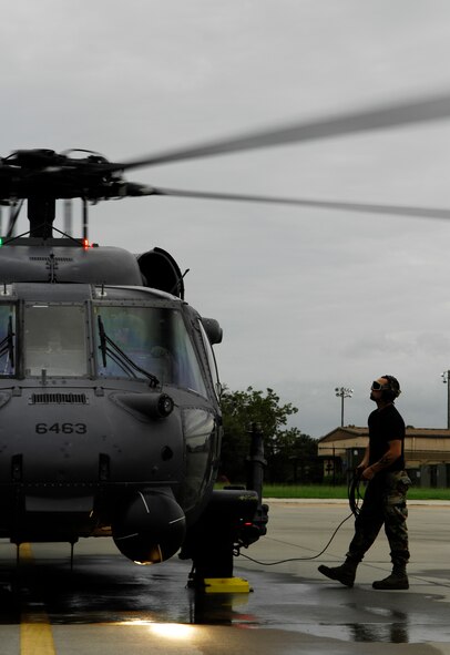 MOODY AIR FORCE BASE, Ga. -- Staff Sgt. Jason Chavies, 723rd Aircraft Maintenance Squadron HH-60G Pave Hawk crew chief, performs a pre-deployment inspection on a 41st Rescue Squadron aircraft here Aug. 31. The 41st RQS is preparing to enter storm ravaged areas of the Gulf Coast to provide rescue support and humanitarian assistance as part of the national response framework for Hurricane Gustav. (U.S. Air Force photo by Tech. Sgt. Parker Gyokeres) 
