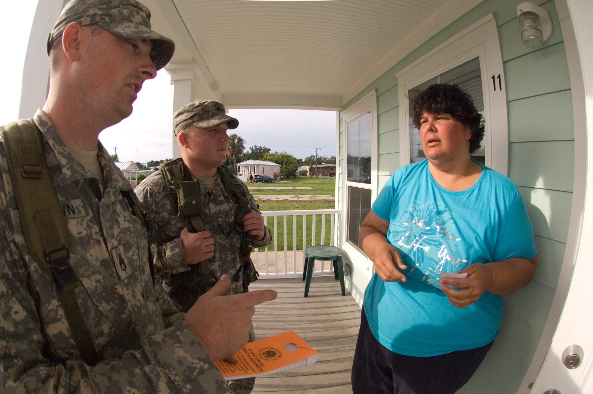 Army National Guard Sgt Thomas Brown, right, and Staff Sgt Cory Brown, notify mobile home resident Charlotte Wright about a mandatory evacuation order in Gulfport, Miss. Aug. 31. All Federal Emergency Management Agency trailer residents in Gulfport are under a mandatory evacuation order in anticipation of Hurricane Gustav making landfall. Both guardsmen are from A Troop, 1-98 Cavalry Regiment, Pontotoc, Miss. (U.S. Air Force photo/Master Sgt. Jack Braden)
