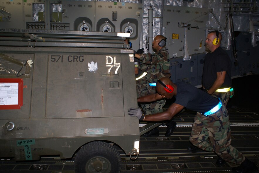 TRAVIS AIR FORCE BASE, Calif. ? A Total Force contingency of active-duty and reserve aerial port Airmen from the 60th Aerial Port Squadron here and the 87th APS at Wright-Patterson AFB, Ohio, load equipment aboard a C-17 Globemaster III for transport to New Orleans International Airport on Aug. 30. Airmen from McChord Air Force Base, Wash., delivered an Air Force contingency response team and 15,500 lbs of cargo to New Orleans in preparation for Hurricane Gustav. (U.S. Air Force Photo by Staff Sgt. Oshawn Jefferson)