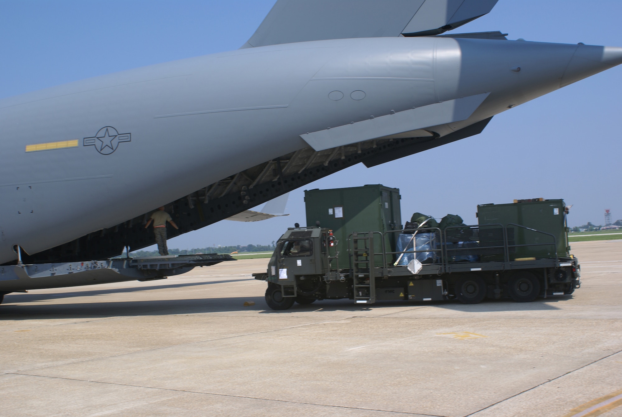 NEW ORLEANS ? Members of the 615th Contingency Response Wing aerial port flight from Travis Air Force Base, Calif., unload cargo from a C-17 Globemaster III at New Orleans International Airport on Aug. 30.  Airmen from McChord Air Force Base, Wash., delivered an Air Force contingency response team and 15,500 lbs of cargo to New Orleans in preparation for Hurricane Gustav. (U.S. Air Force Photo by Staff Sgt. Oshawn Jefferson)                   