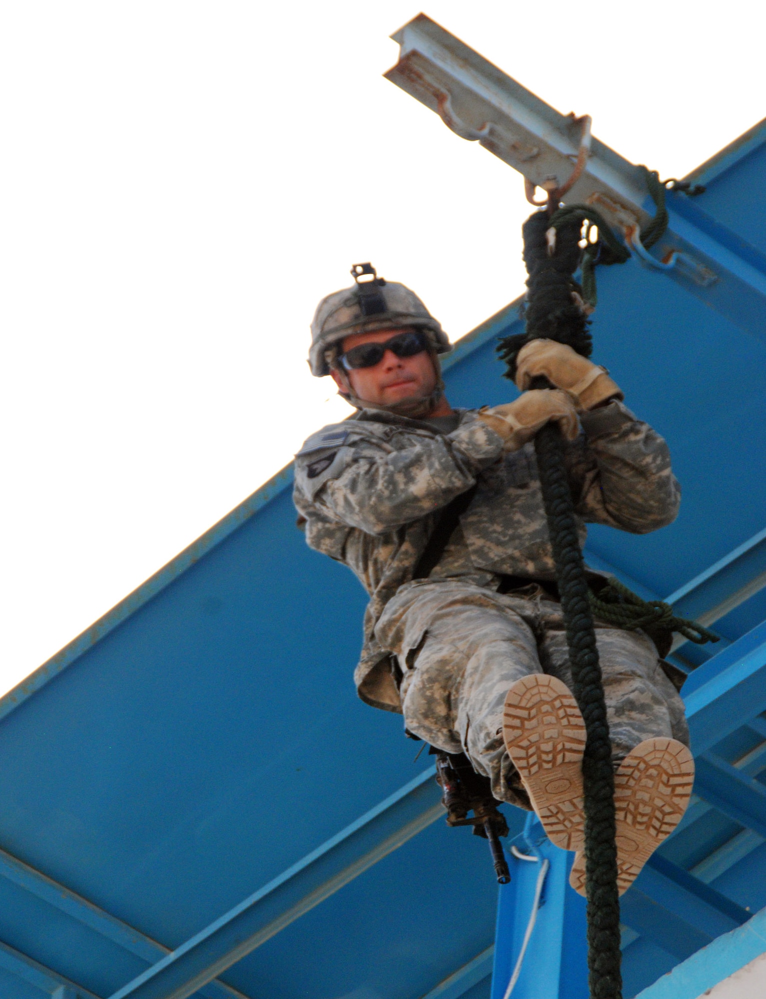 A Soldier from the Pathfinder Detachment [Task Force Out Front] descends a fast rope during a tower training exercise at Forward Operating Base Fenty recently. (U.S. Army photo by Spc. George Welcome)