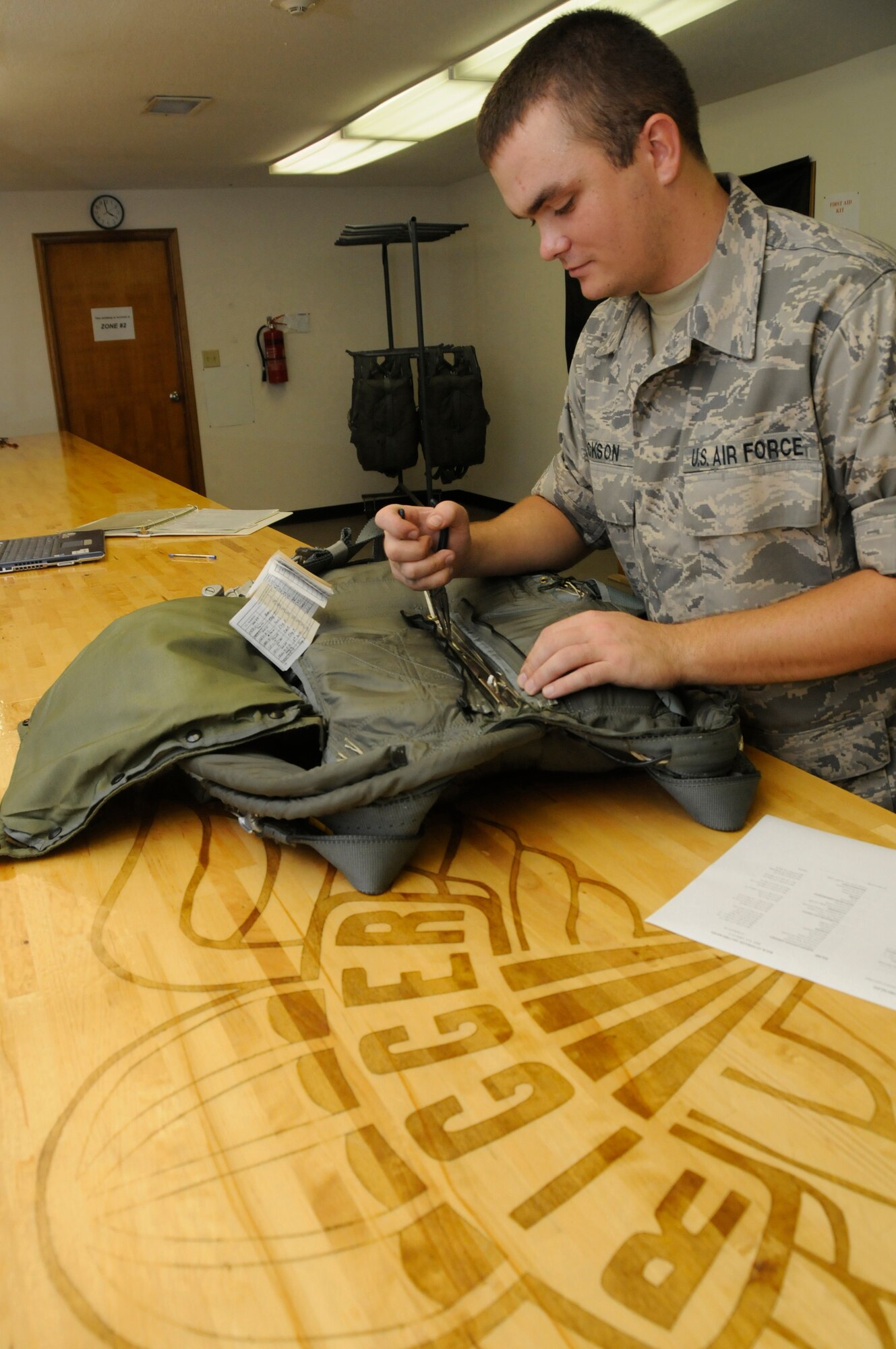 Senior Airman Michael Jackson, assigned to the 379th Expeditionary Operations Support Squadron, uses pliers to set ripcord pins of a BA22 automatic back parachute Aug. 30, 2008, at an undisclosed air base in Southwest Asia. Airman Jackson and other aircrew life support technicians assigned to the 379th EOSS ensure reliability of life support equipment for Airmen flying missions in support of Operations Iraqi Freedom, Enduring Freedom and Joint Task Force-Horn of Africa. Airman Jackson, a native of Lynchburg, Va., is deployed from Pope Air Force Base, N.C. (U.S. Air Force photo by Staff Sgt. Darnell T. Cannady)