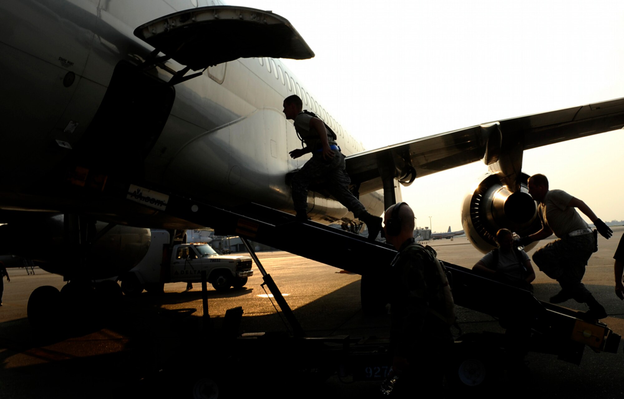 Airmen from the 615th Contingency Response Wing at Travis Air Force Base, Calif., prepare to load luggage at the Louis Armstrong International Airport in New Orleans Aug. 30. Officials with the Federal Emergency Management Agency and the Department of Defense have chartered flights to transport evacuees of Hurricane Gustav to destinations safely outside the path of the hurricane.  (U.S. Air Force photo/Staff Sgt. Shawn Weismiller)