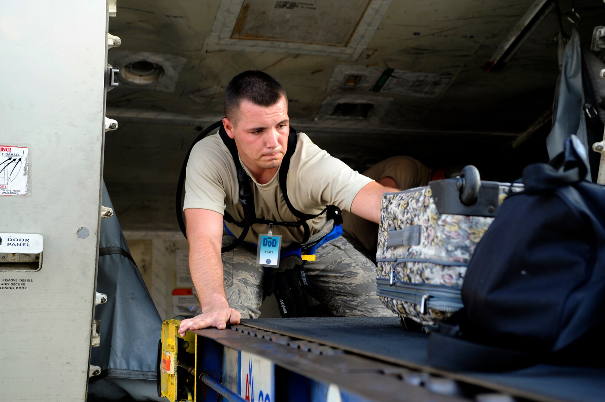 An Airman from the 615th Contingency Response Wing at Travis Air Force Base, Calif., loads luggage at the Louis Armstrong International Airport in New Orleans Aug. 30. Officials with the Federal Emergency Management Agency and the Department of Defense have chartered flights to transport evacuees of Hurricane Gustav to destinations safely outside the path of the hurricane.  (U.S. Air Force photo/Staff Sgt. Shawn Weismiller)