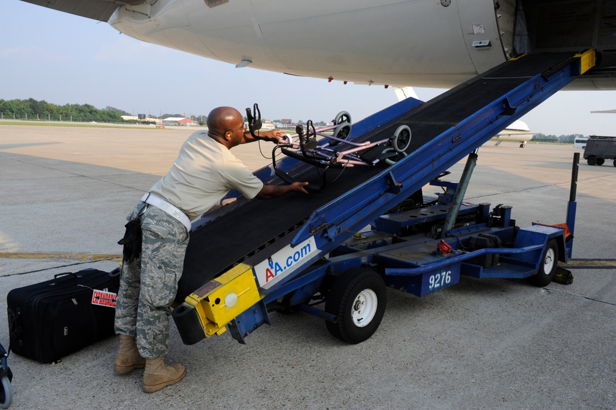 Tech. Sgt. Cedric Scott loads luggage at the Louis Armstrong International Airport in New Orleans Aug. 30.  Officials with the Federal Emergency Management Agency and the Department of Defense have chartered flights to transport evacuees of Hurricane Gustav to destinations safely outside the path of the hurricane.  Sergeant Scott is from the 615th Contingency Response Wing at Travis Air Force Base, Calif.  (U.S. Air Force photo/Staff Sgt. Shawn Weismiller)
