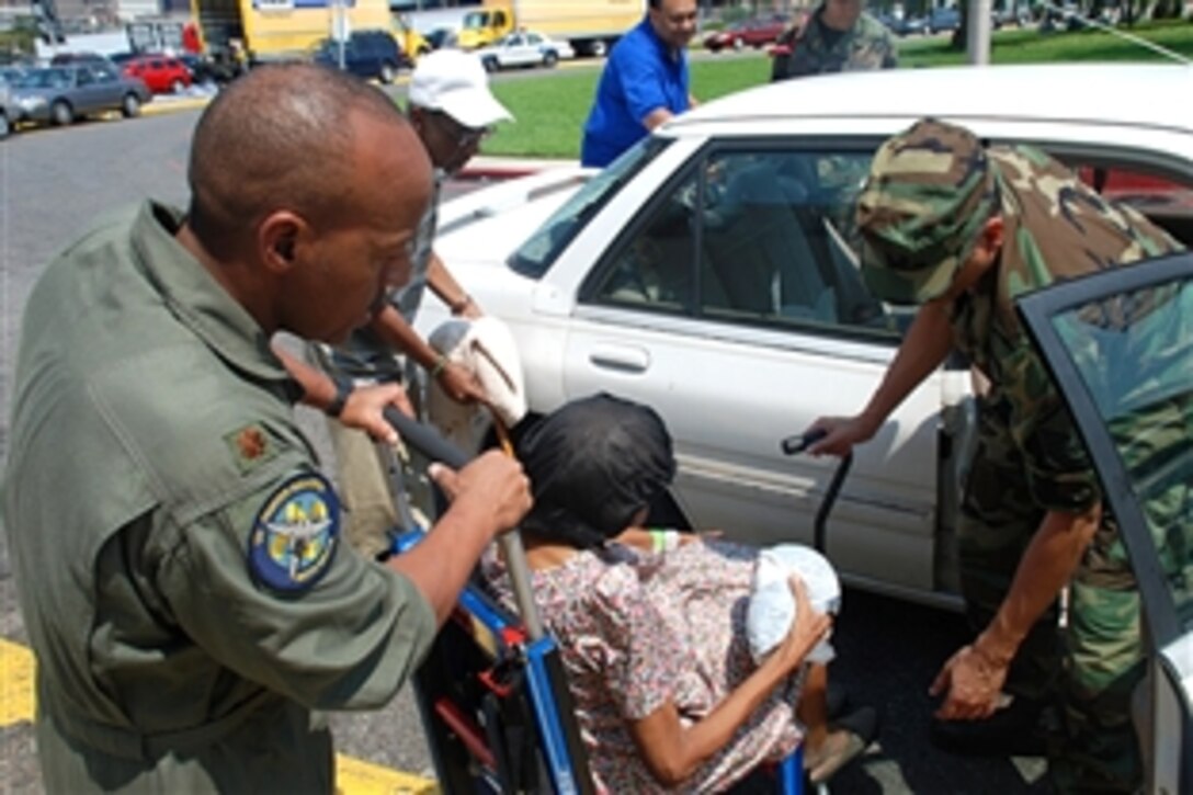 Members of the Louisiana Air National Guard medical team assist a special-needs resident as she prepares to be evacuated before the arrival of Hurricane Gustav at the Union Passenger Terminal Station in New Orleans on Aug. 30, 2008. 