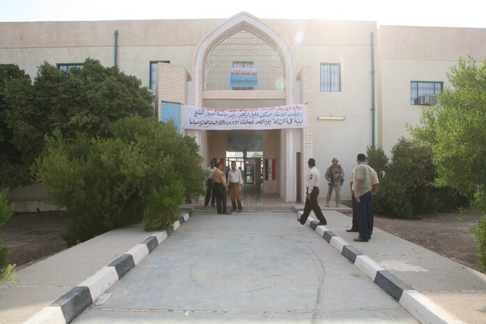 RAMADI, Iraq (August 31, 2008) – Iraqi citizens stand outside the Anbar Agricultural College before the grand opening August 31. The college was vacated due to insurgent attacks in June 2004 until Coalition forces secured the area and used it as a combat outpost two years later. ::r::::n::In 2007, Coalition forces completely demilitarized the campus and turned it over to the province, and in February funding was approved to renovate it back to its original condition. Civil Affairs Detachment 2 and 1st Battalion, 9th Marines, took the lead on the reconstruction efforts. (Official U.S. Marine Corps photo by Lance Cpl. Casey Jones) (RELEASED)::r::::n::