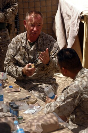 Lieutenant Gen. Samuel T. Helland, commander of Marine Corps Forces Central Command, talks to Gunnery Sgt. Omar Palaciosreal, Team 1 leader, 3rd Civil Affairs Group, Task Force 2d Battalion, 7th Marine Regiment, 1st Marine Division, during his Aug. 31 visit to Forward Operating Base Delaram, Afghanistan. (Official U.S. Marine Corps photo by Cpl. Ray Lewis)
