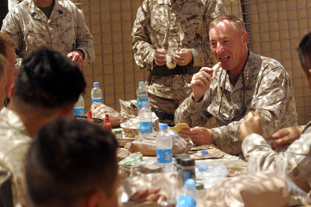 Lieutenant Gen. Samuel T. Helland, commander of Marine Corps Forces Central Command, eats a Meal-Ready-to-Eat lunch with Marines assigned to Company G, Task Force 2d Battalion, 7th Marine Regiment, 1st Marine Division, during his Aug. 31 visit to Forward Operating Base Delaram, Afghanistan.  (Official U.S. Marine Corps photo by Cpl. Ray Lewis)