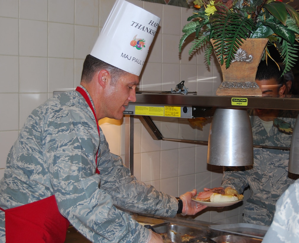 Maj. Paul Corman, 365th Training Squadron Director of Operations, serves Thanksgiving meals to Sheppard Airmen Nov. 27. Many Sheppard officers and senior enlisted members manned all of the food stations at the Sagebrush Dining Facility in this year's event. (U.S. Air Force photo/Staff Sgt. Vernon Cunningham)