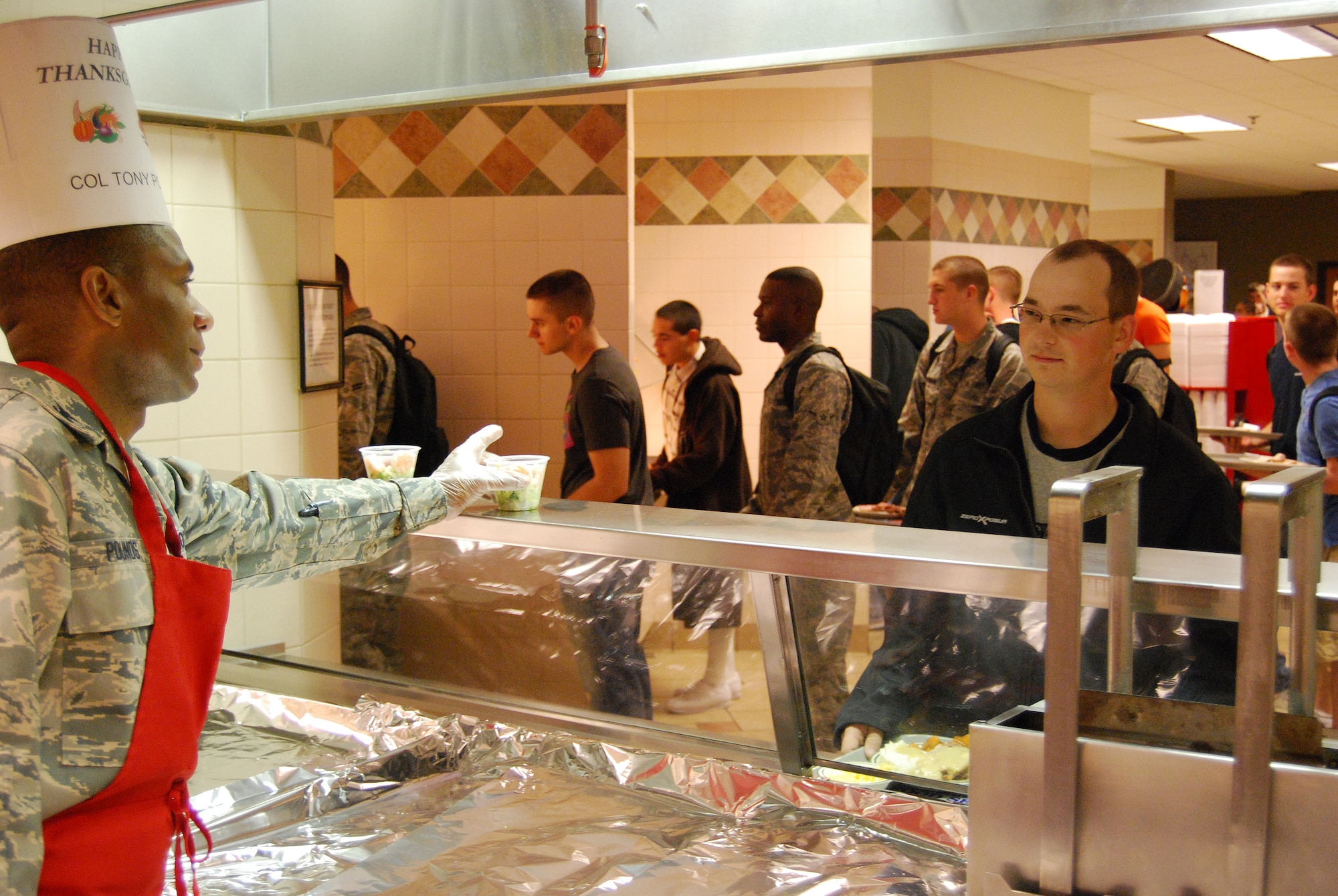 Col. Tony Pounds, 782nd Training Group commander, serves Thanksgiving meal to Sheppard Airmen Nov. 27. Many Sheppard officers and senior enlisted members manned all of the food stations at the Sagebrush Dining Facility in this year's event. (U.S. Air Force photo/Staff Sgt. Vernon Cunningham)