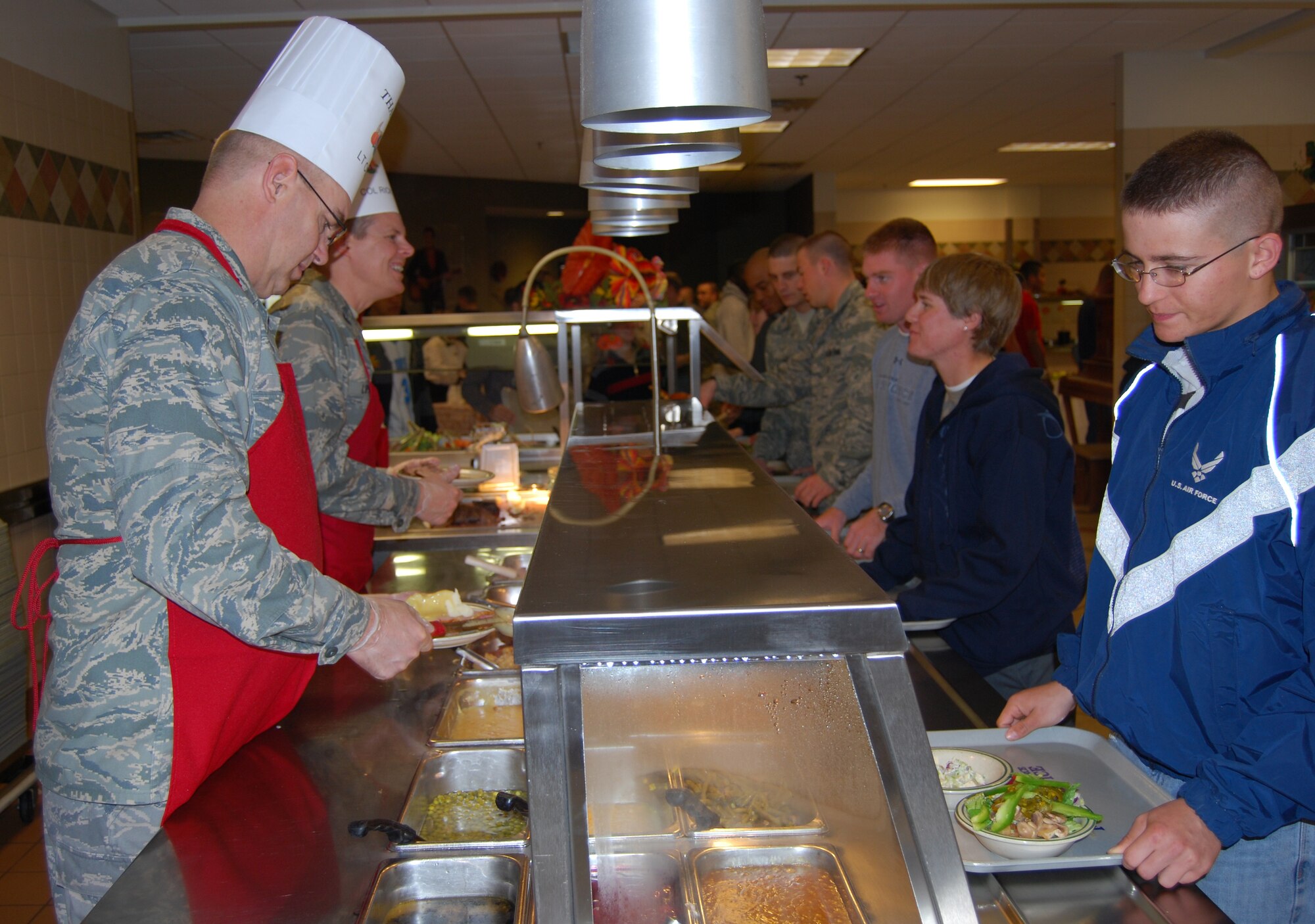 Lt. Col. Matthew Bobb, 366 Training Squadron commander, and Col. Richard Lipsey, 82nd Mission Support Group commander, served Thanksgiving meal to Sheppard Airmen Nov. 27.  Many Sheppard officers and senior enlisted members manned all of the food stations at the Sagebrush Dining Facility in this year's event. (U.S. Air Force photo/Staff Sgt. Vernon Cunningham)