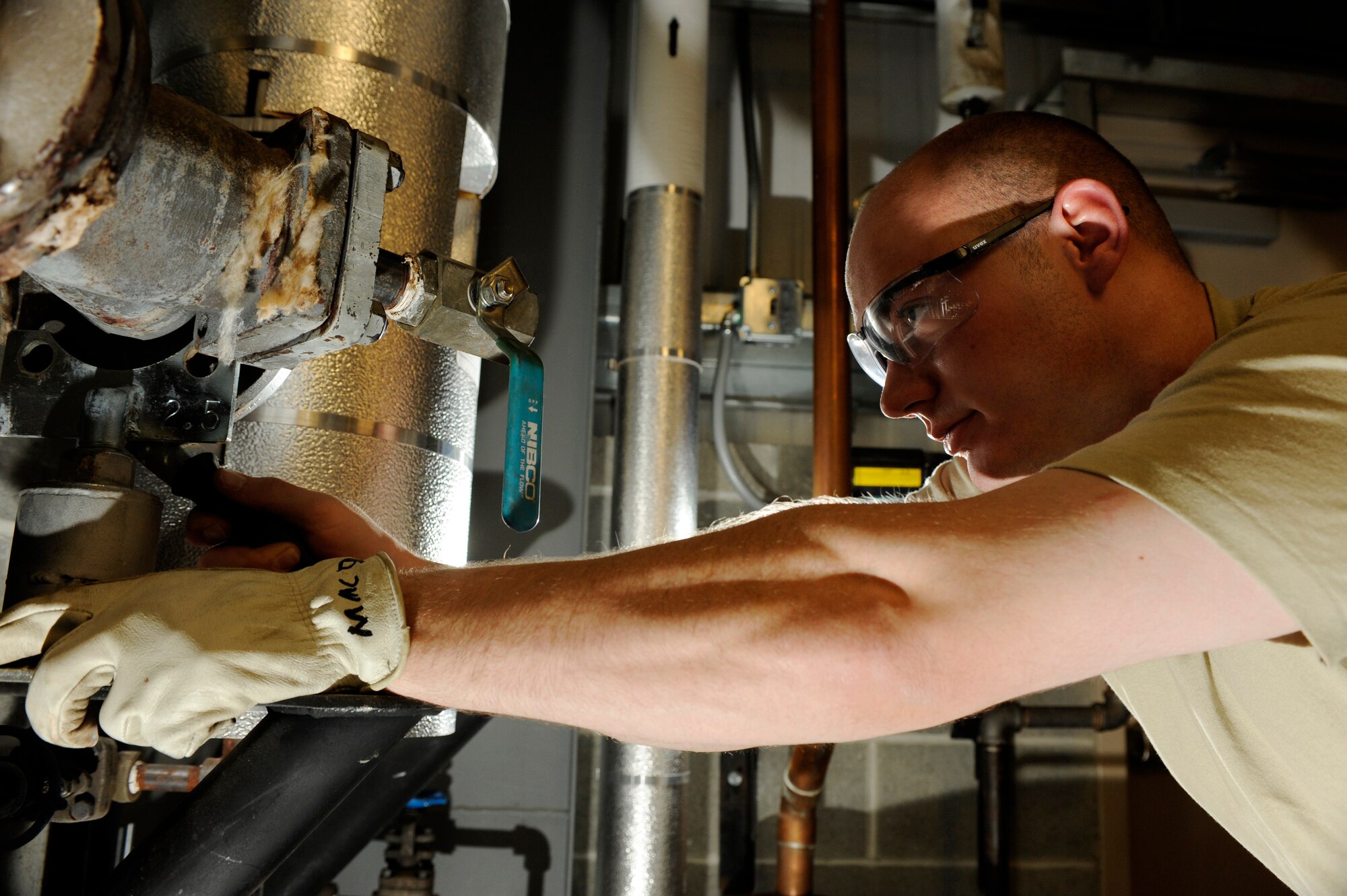 Airman 1st Class Max Macdonald removes a gasket from the pipe fixture Dec. 1, 2008, at Eielson Air Force Base, Alaska. The heating ventilation air conditioning shop is responsible for maintaining all base-wide facility heating and air conditioner units. A quick repair to restore heat in a building will prevent the water in the pipes from freezing, causing major damage. Airman Macdonald is assigned to the 354th Civil Engineer Squadron HVAC shop.  (U.S. Air Force photo/Senior Airman Jonathan Snyder)