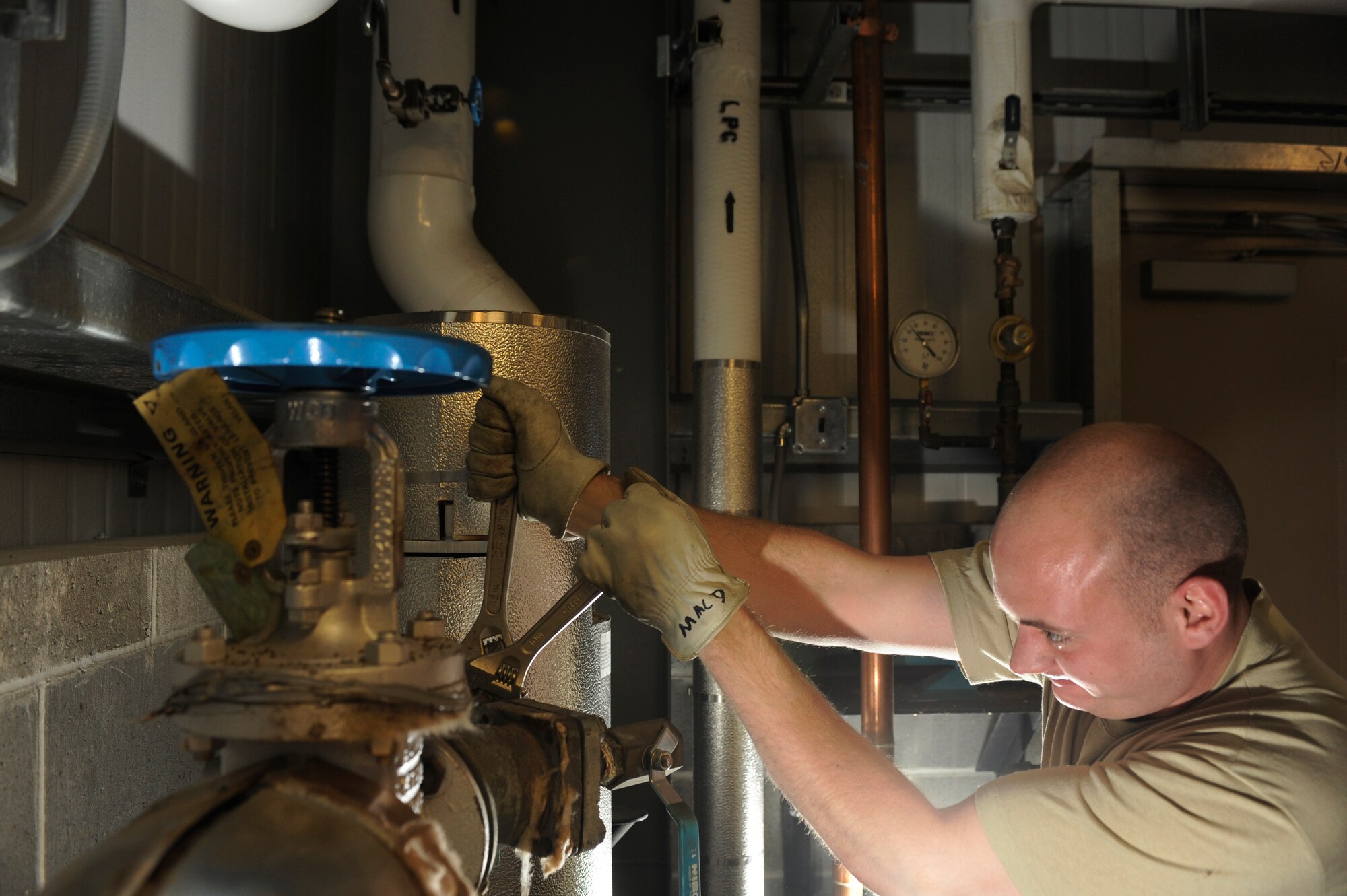 Airman 1st Class Max Macdonald loosens heating pipes to replace a gasket Dec. 1, 2008, at Eielson Air Force Base, Alaska. The heating ventilation air conditioning shop is responsible for maintaining all base-wide facility heating and air conditioner units. A quick repair to restore heat in a building will prevent the water in the pipes from freezing, causing major damage. Airman Macdonald is assigned to the 354th Civil Engineer Squadron HVAC shop.  (U.S. Air Force photo/Senior Airman Jonathan Snyder)
