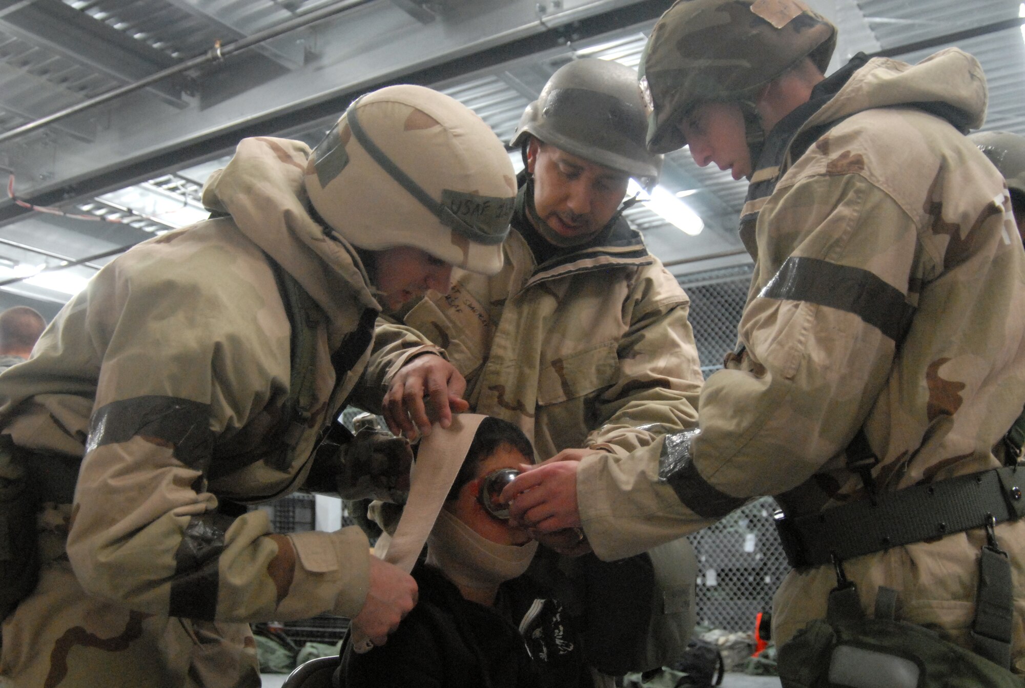 Edwards Airmen treat an injured victim as part of Self Aid Buddy Care training for the Targeted Readiness Inspection training Nov. 22 at the Mobility Processing Center. This is part of the base's Unit Compliance Inspection Jan. 22. The inspection evaluates areas mandated by law as well as mission areas identified by Air Force and Air Force Materiel Command senior leadership as critical or important to the health and performance of the base.