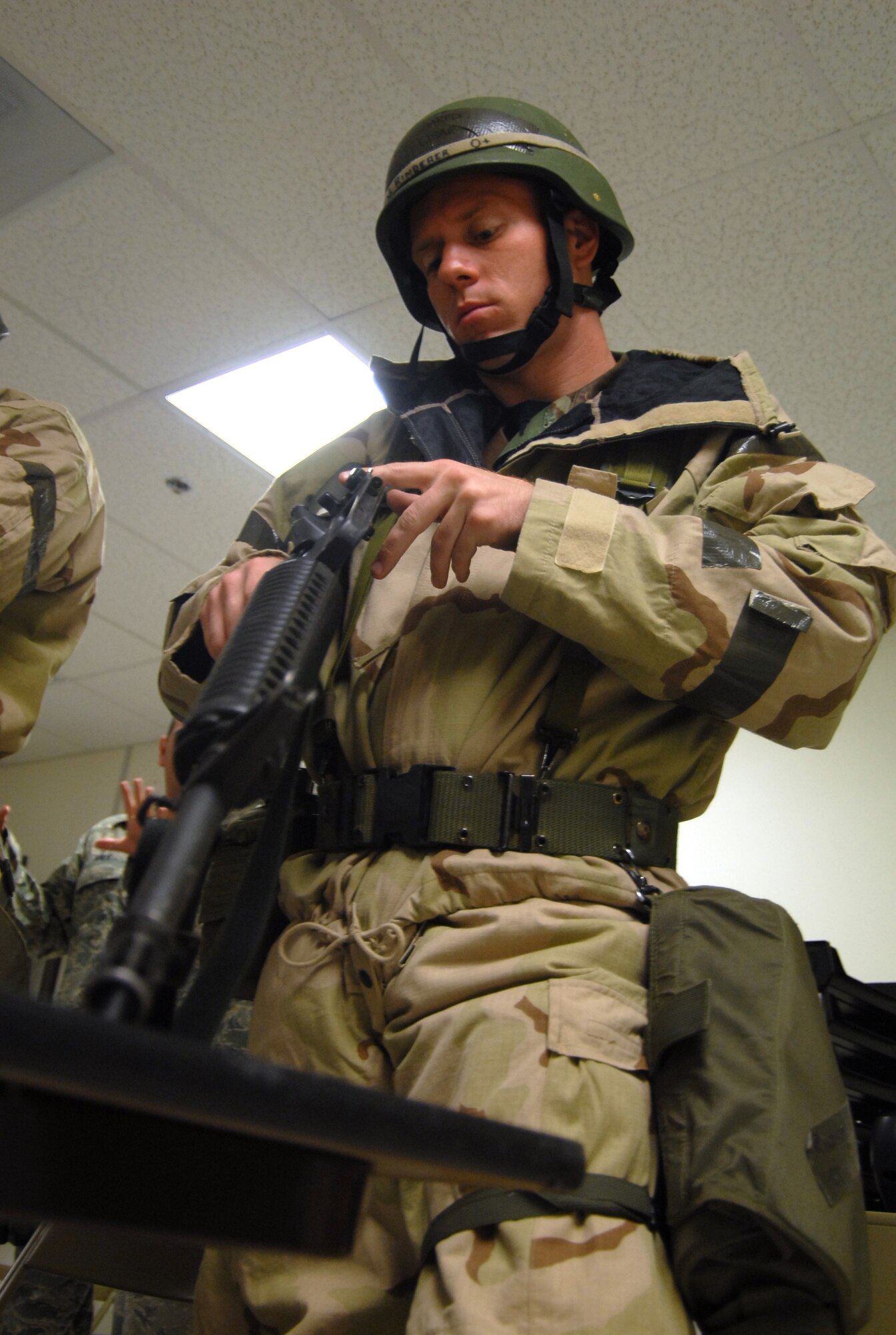 Staff Sgt. Jared Rinderer, 412th Aircraft Maintenance Squadron F-22 Raptors weapons load crew member, clears his M-16 rifle during a familiarization class for the Targeted Readiness Inspection training at the Mobility Processing Center Nov. 22. (Air Force photo by Senior Airman Julius Delos Reyes)