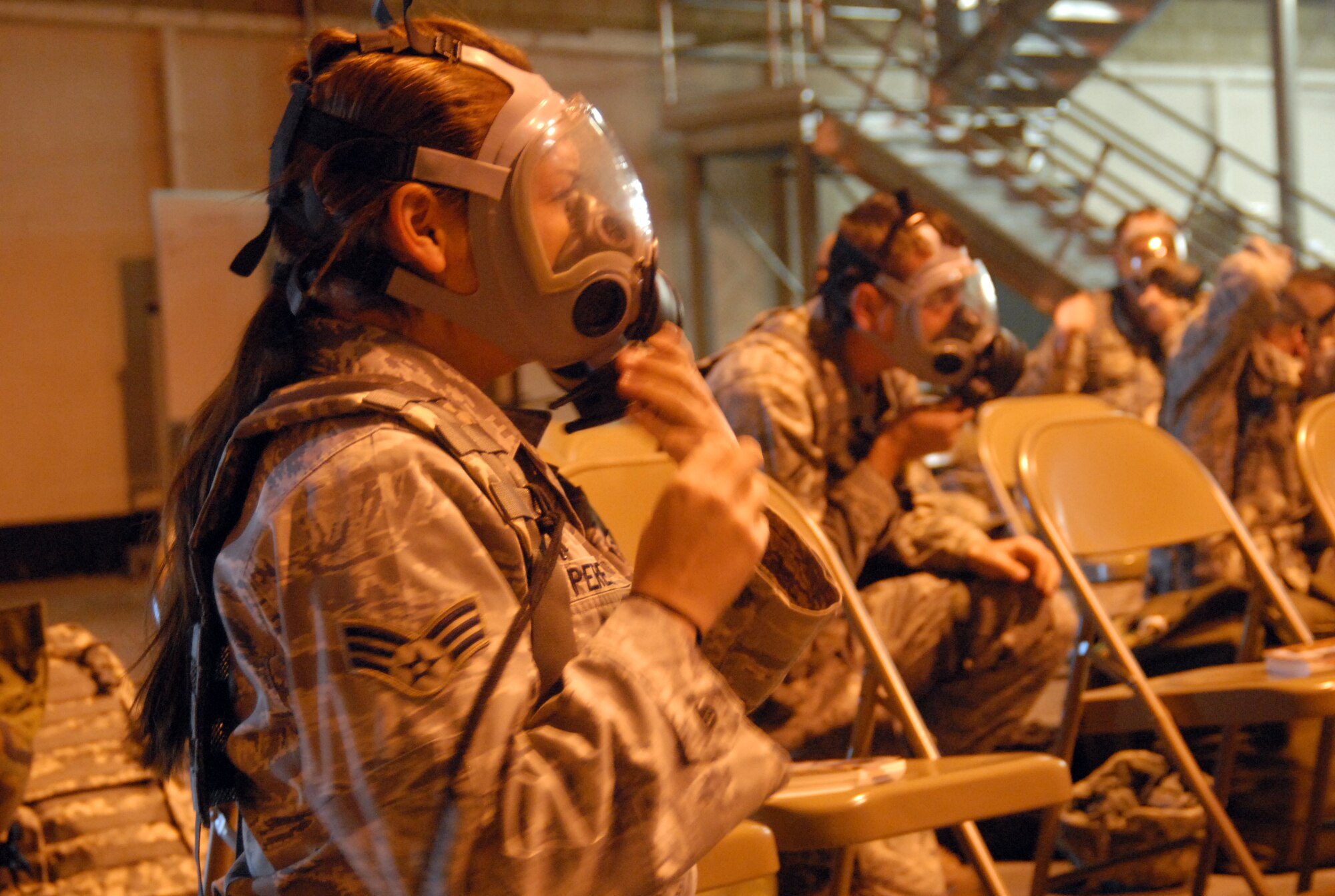 Edwards Airmen practice donning a gas mask for a Chemical, Biological, Radiological and Nuclear training Nov. 22. The Air Force Materiel Command Inspector General team will assess the base's readiness program to include its mobility processing and the Airmen's ability to survive and operate in a deployed environment. (Air Force photo by Senior Airman Julius Delos Reyes)