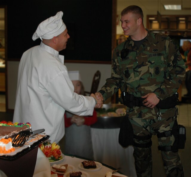 Chief Master Sgt. Kevin Candler, Command Chief Master Sergeant of the 75th Air Base Wing and Ogden Air Logistics Center, greets Airman Ryan Richards, 75th Security Forces Squadron, at the Thanksgiving meal held at Hillcrest Dining Facility, Nov. 27. 