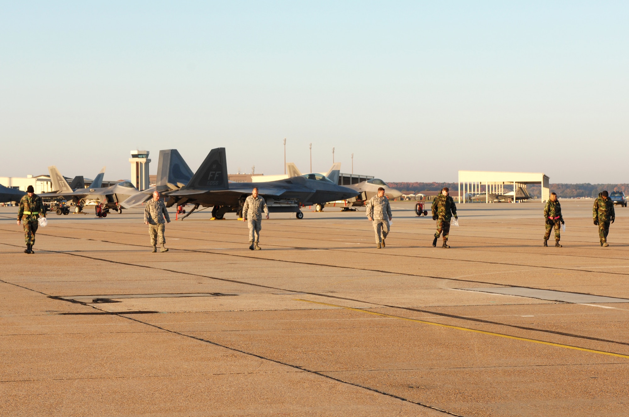 LANGLEY AIR FORCE BASE, Va. – Airmen from the 1st Component Maintenance Squadron walk along the flight line to look for debris such as rocks, bolts, screws and fasteners during a foreign object damage or FOD walk Nov. 10. FOD is any damage to an aircraft, engine, aircraft system, component, or aircraft ground equipment caused by a foreign object. (U.S. Air Force photo/Tech. Sgt. April Wickes) 
