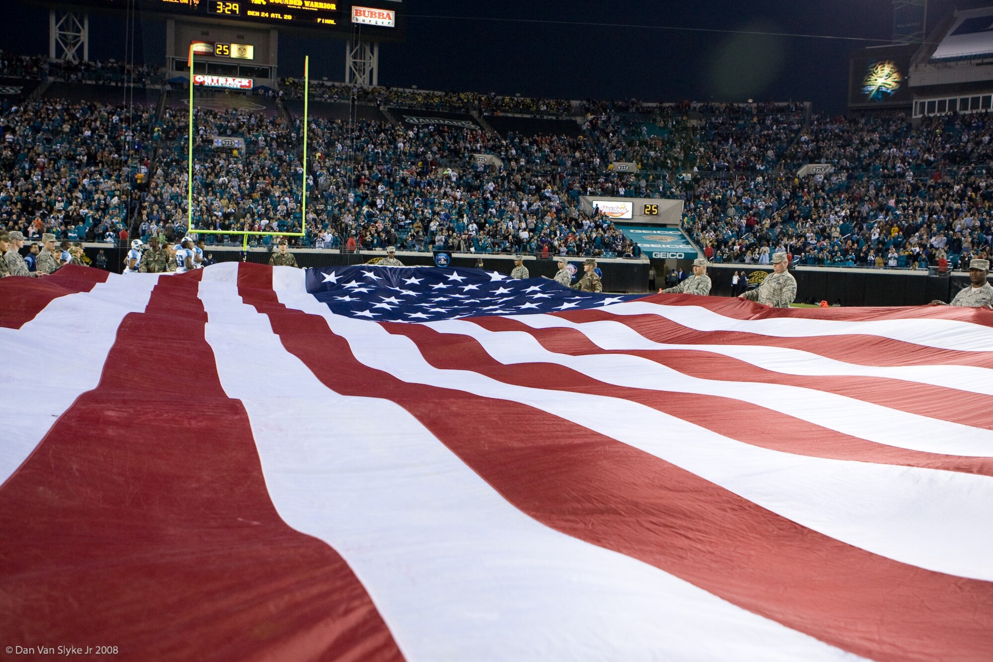 Tyndall Air Force Base Airmen held up the United States Flag during halftime at the Jacksonville Jaguars and Tennesse Titans football game Nov. 16.  Airmen who recently returned from deployment participated in the Military Appreciation day. (Courtesy Photo)
