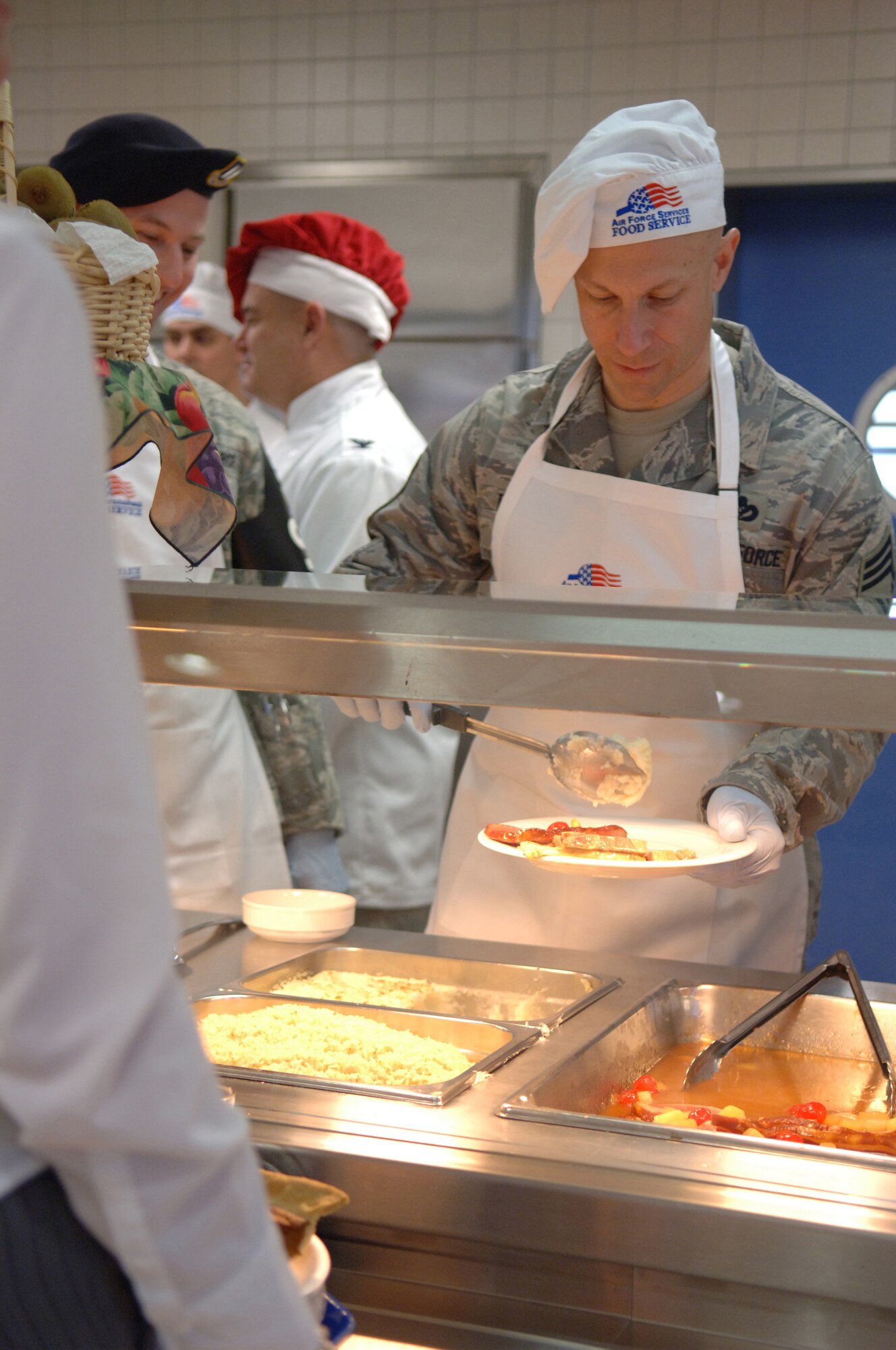 Chief Master Sgt. Dale Brocious, 431st Air Base Group, serves mashed potatoes to a patron of the Lindberg Hof Dining Facility during Thanksgiving meal, Kapaun Air Station, Germany, Nov. 27, 2008. (U.S. Air Force photo by Senior Airman Levi Riendeau)