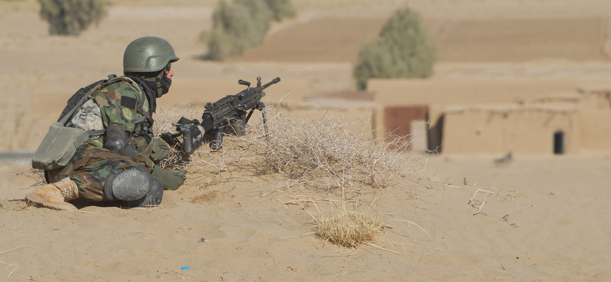 Southern Afghanistan -- An Afghan Commando from the 205th Kandak mans an over-watch position Sunday during an operation in Maywand District, Kandahar province, about 75 kilometers west of Kandahar city.  A search of the area yielded illegal drugs, bomb-making materials and weapons.