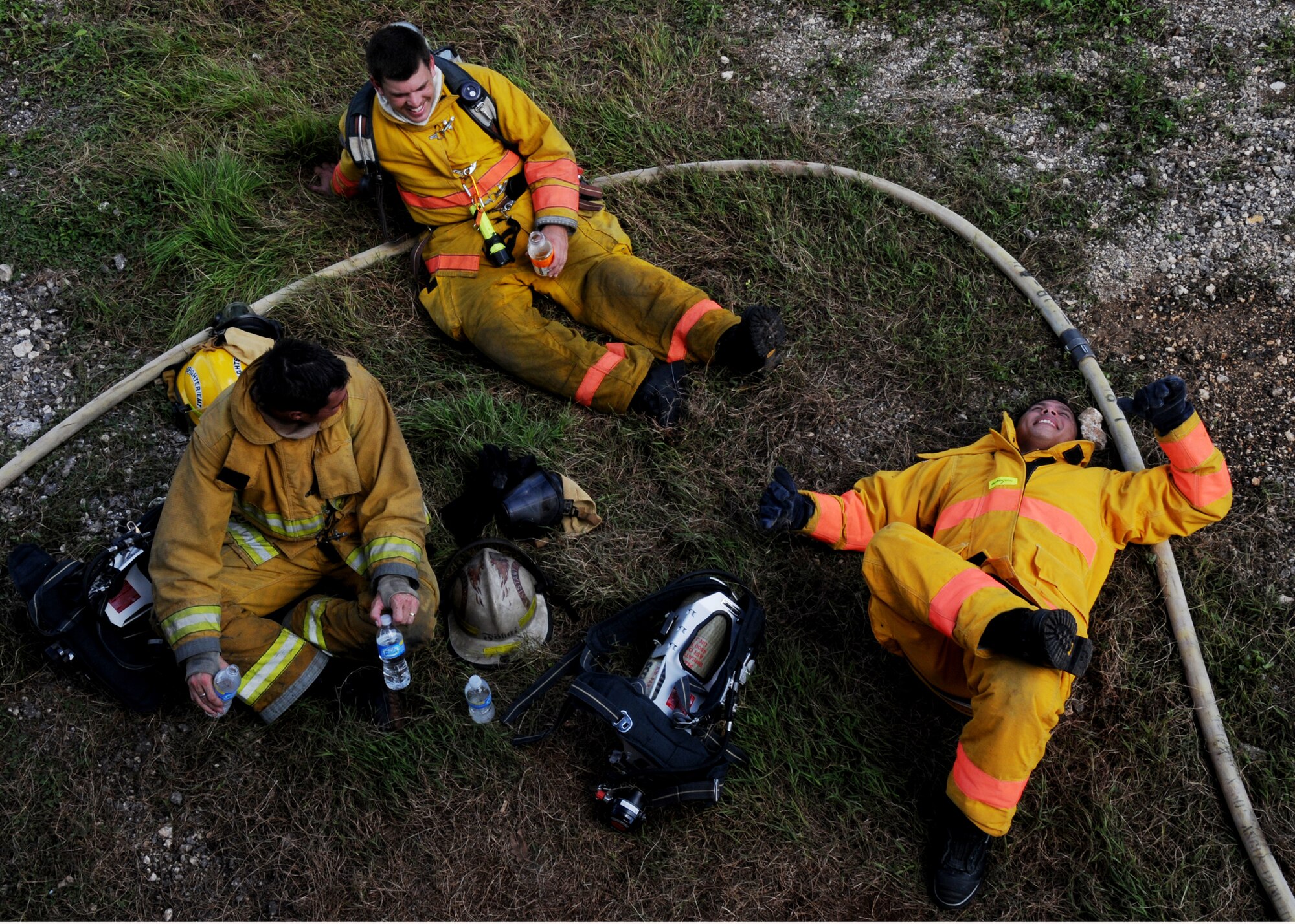 ANDERSEN AIR FORCE BASE, Guam - U.S. Navy Firemen relax under the shade after conducting Structural Fire Training here Nov. 22. Eight new Navy Fire Cadets and more than 54 seasoned firemen took part in the week long training to meet  certification and re-certification requirements. (U.S. Air Force photo by Senior Airman Nichelle Griffiths)