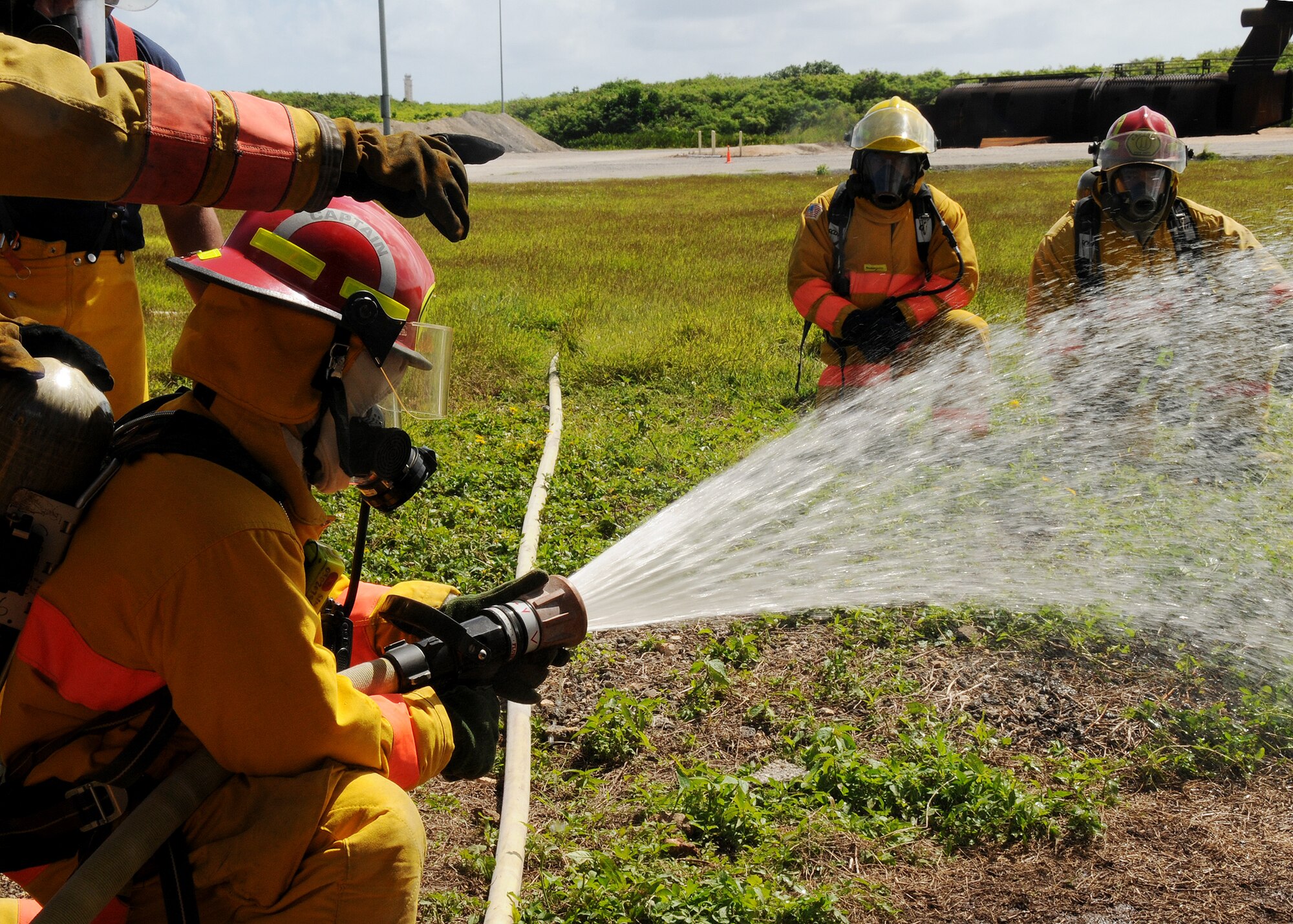 ANDERSEN AIR FORCE BASE, Guam -U.S. Navy Firemen from Naval Base Guam check the water pressure of the fire hose before conducting the interior structural fire training here Nov. 22. The week long Fireman 1 and Fireman 2 training was held to obtain certifications for new firefighters and to help them learn from veteran members of the department. (U.S. Air Force photo by Senior Airman Nichelle Griffiths)