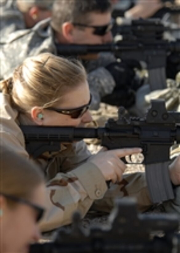 U.S. Navy Petty Officer 1st Class Jessica Norton, with Explosive Ordnance Disposal Mobile Unit One Company 1/3, zeros her M-4 rifle at the range at Contingency Operating Base Speicher, Iraq, on Nov. 27, 2008.  