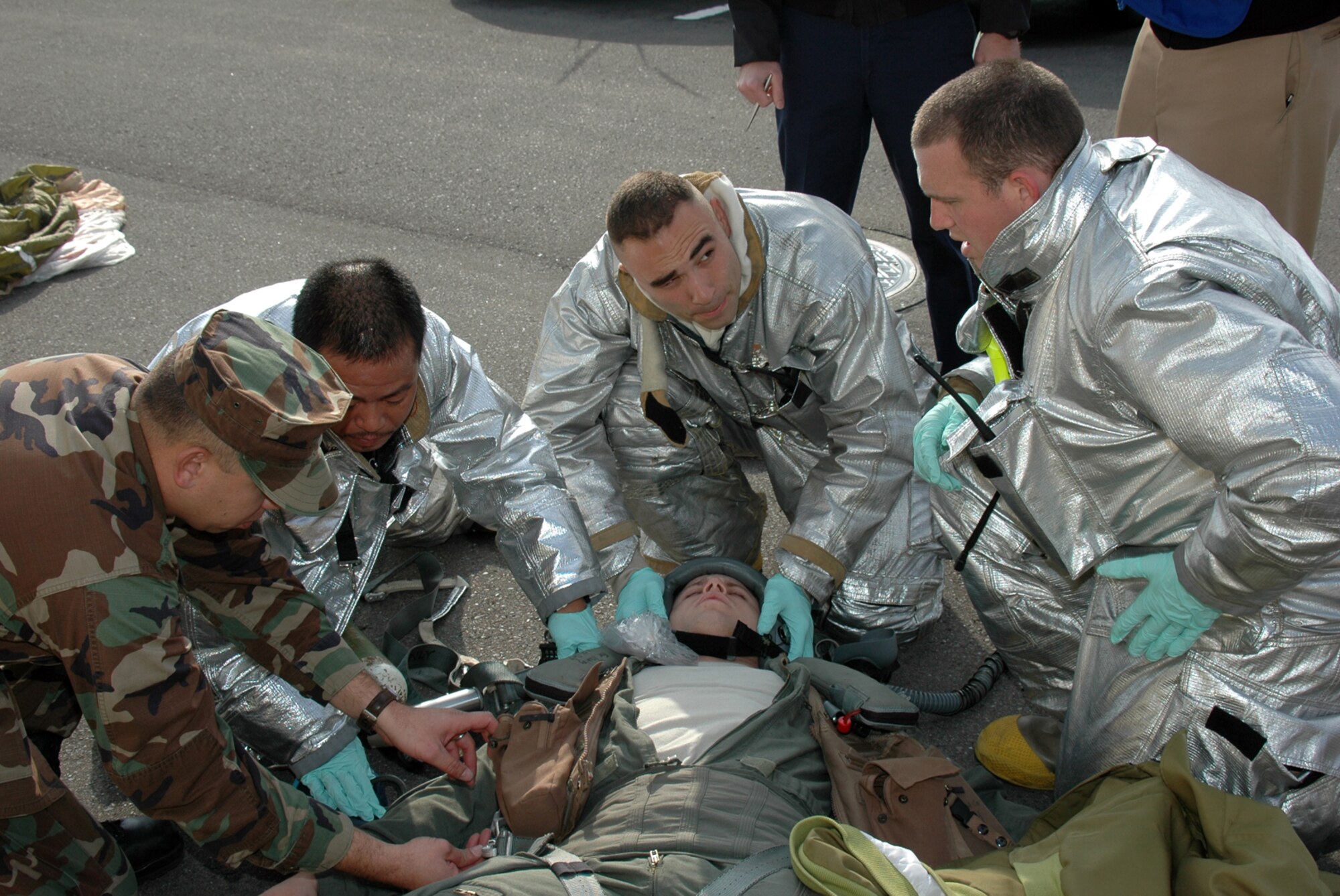 MISAWA AIR BASE, Japan -- Petty Officer 1st Class Clifford Martin, Naval Air Facility Misawa, and Yoshi Vaki, Senior Airman Sean Willeford, and Staff Sgt. Kyle Scritchfield, 35th Civil Engineer Squadron, evaluate the condition of a simulated downed aviator Nov. 17, 2008. The scene was part of an exercise, in conjunction with a triennial Air Force Unit Compliance Inspection. Though Air Force units were the focus of the inspection team, personnel and assets from the Naval Air Facility played supporting roles. (U.S. Navy photo by Chief Petty Officer Brian Naranjo)