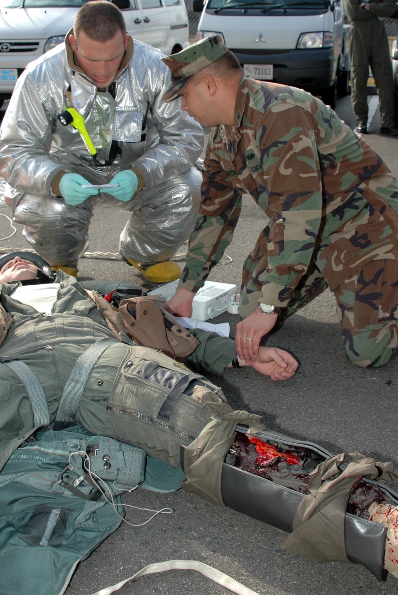 MISAWA AIR BASE, Japan -- Staff Sgt. Kyle Scritchfield, 35th Civil Engineer Squadron, and Petty Officer 1st Class Clifford Martin, Naval Air Facility Misawa, evaluate the condition of a simulated downed aviator, during an exercise Nov. 17, 2008, as part of a triennial Air Force Unit Compliance Inspection. Though Air Force units were the focus of the inspection team, personnel and assets from the Naval Air Facility played supporting roles. (U.S. Navy photo by Chief Petty Officer Brian Naranjo)