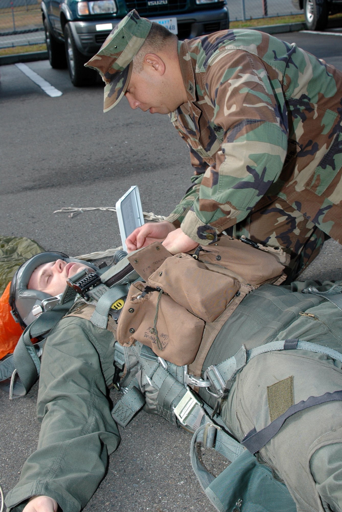 MISAWA AIR BASE, Japan -- Petty Officer 1st Class Clifford Martin, Naval Air Facility Misawa, performs basic first aid on a simulated downed aviator, during an exercise Nov. 17, 2008, as part of a triennial Air Force Unit Compliance Inspection. Airman 1st Class Aaron Laver volunteered to play the role of the downed aviator. (U.S. Navy photo by Chief Petty Officer Brian Naranjo)