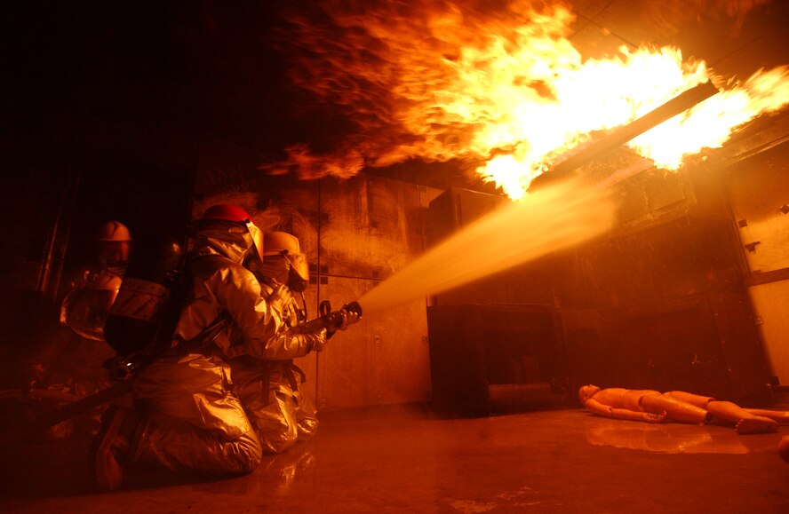 Airmen from the 18th Civil Engineer Squadron Fire Department conduct a live fire training scenario at the Silver Flag training site Dec. 2 during Exercise Beverly High 09-01 at Kadena Air Base, Japan. The 18th Wing is participating in a Local Operational Readiness Exercise to test the readiness of Kadena Airmen. 
(U.S. Air Force photo/Tech. Sgt. Rey Ramon)     