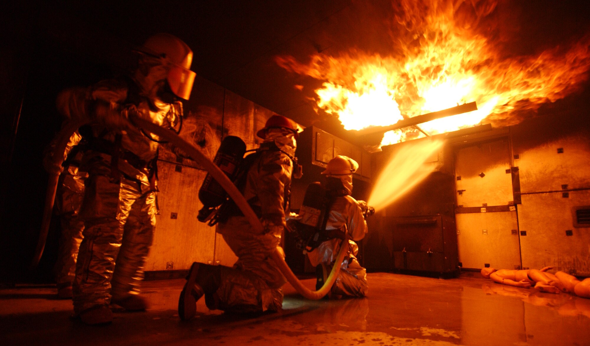 Airmen from the 18th Civil Engineer Squadron Fire Department conduct a live fire training scenario at the Silver Flag training site Dec. 2 during Exercise Beverly High 09-01 at Kadena Air Base, Japan. The 18th Wing is participating in a Local Operational Readiness Exercise to test the readiness of Kadena Airmen. 
(U.S. Air Force photo/Tech. Sgt. Rey Ramon)  