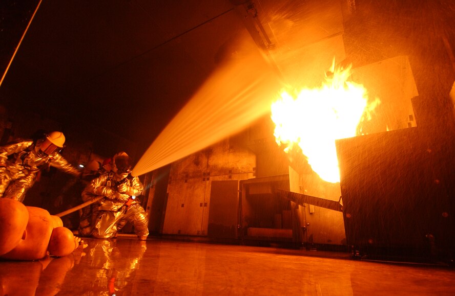 Airmen from the 18th Civil Engineer Squadron Fire Department conduct a live fire training scenario at the Silver Flag training site Dec. 2 during Exercise Beverly High 09-01 at Kadena Air Base, Japan. The 18th Wing is participating in a Local Operational Readiness Exercise to test the readiness of Kadena Airmen. 
(U.S. Air Force photo/Tech. Sgt. Rey Ramon)  
