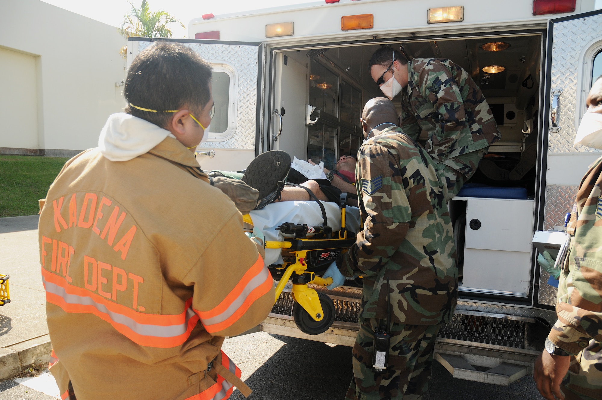Kadena fire fighters and members of the 18th Medical Group load a Kadena High School student into an ambulance following a simulated contamination of the high school's food supply during a Local Operational Readiness Exercise at Kadena Air Base, Japan  Dec. 02, 2008. The simulation is part of a Local Operational Readiness Exercise meant to test the operational readiness of Kadena Airmen. 
(U.S. Air Force photo/Airman 1st Class Chad Warren)
