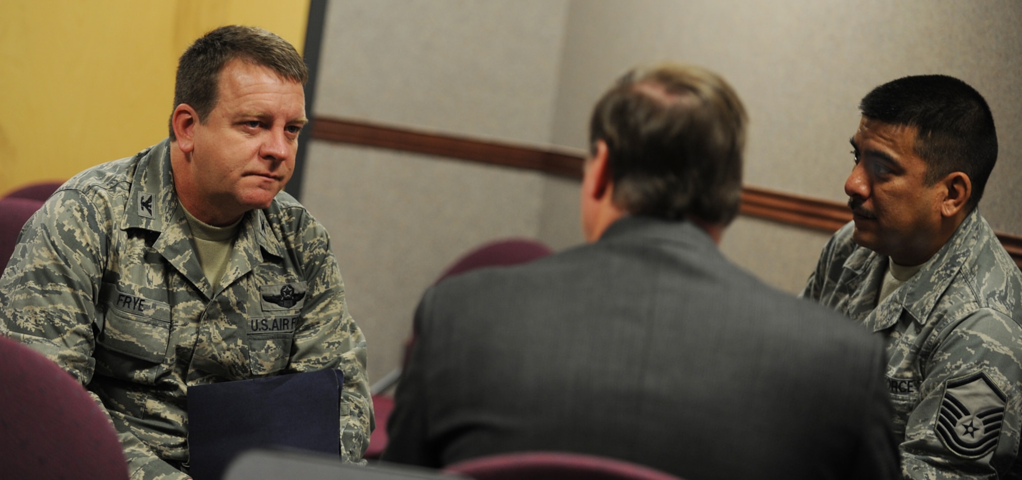 Col. Edsel A. "Archie" Frye Jr., Master Sgt. Edward Deluna and a Site Activation Task Force member talk about how growth within the 931st Air Refueling Group will affect security forces at McConnell Air Force Base, Kan. The task force, more commonly known as a SATAF, received a total-force welcome to the base on Dec. 2. Colonel Frye is commander of the 931st and Sergeant Deluna is assigned to the 22nd Air Refueling Wing's security forces. The 931st is an Air Force Reserve unit and the 22nd is its host unit at McConnell. (U.S. Air Force photo/Tech. Sgt. Jason Schaap)