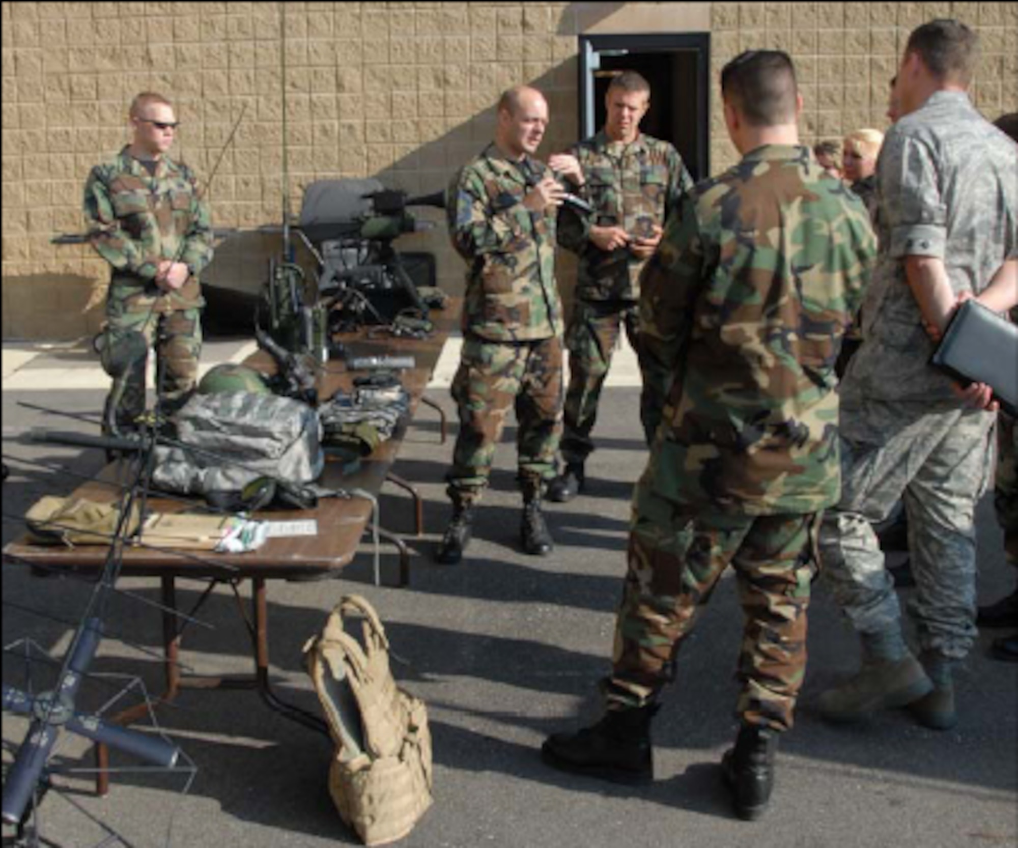 Members from the 182nd Mission Support Group learn about the capabilities of a monocular devices used in air support operations from Senior Master Sgt. Curtt Stevens, 169th ASOS. Photo by Tech. Sgt. Shane P. Hill
