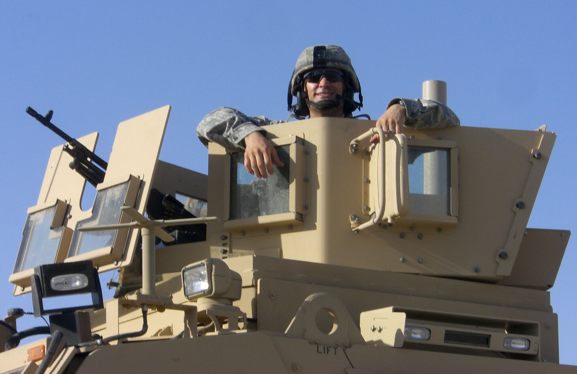Staff Sgt. Kerry Dapron, assigned to the 506th Expeditionary Security Forces Squadron, poses for a photo in a Mine Resistant Ambush Protected, or 'MRAP' turret before beginning a day's mission recently. Sergeant Dapron is deployed with several members of the 302nd Security Forces Squadron in support of Operation Iraqi Freedom. When not deployed, Sergeant Dapron is a fire team leader with the 302nd SFS. (Courtesy photo)