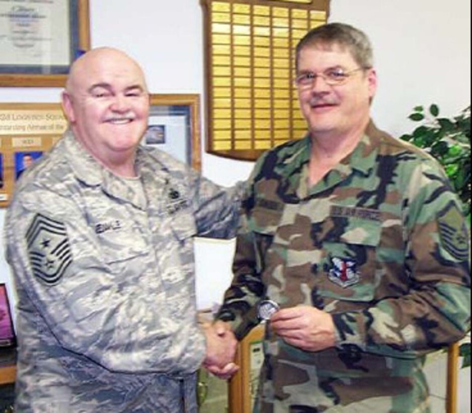 Senior Master Sgt. Steve Schneider receives a Chief’s coin from Command Chief Master Sgt. Steve Eakle for his participation in the annual 182nd Airlift Wing bowling tournament. This was the 25th year for the tournament. 

Schnieder has been coordinating the event for the last five years, but assisted retired Master Sgt. Karl Cooper for the preceding 15 years. He enjoys coordinating the tournament because it gives him a chance to meet and see people from all the squadrons on base. A causal bowler himself, he only bowls occasionally and doesn’t belong to any leagues.

He feels the tournament is a success because “the bowlers in the tournament do a great job of watching out for each other, and has always been a fun event.” This year the tournament had 215 bowlers and occupied 43 lanes at Landmark Lanes in Peoria.