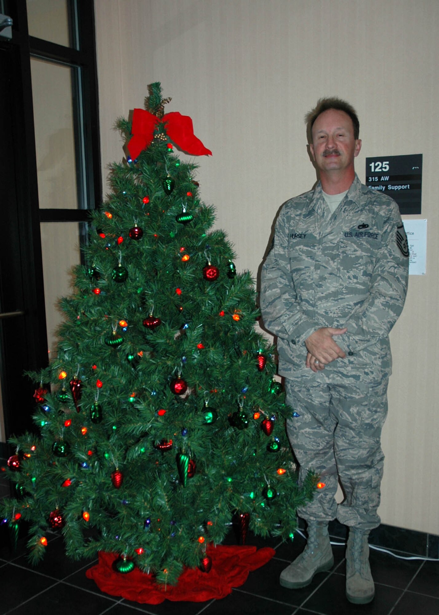 Master Sgt. Sid Hursey, Non Commissioned Officer in Charge for the 315th Family Support Flight, gets a head start on the Christmas season.  Family Support was the first to pull out their Christmas spirit for the upcoming holidays.  