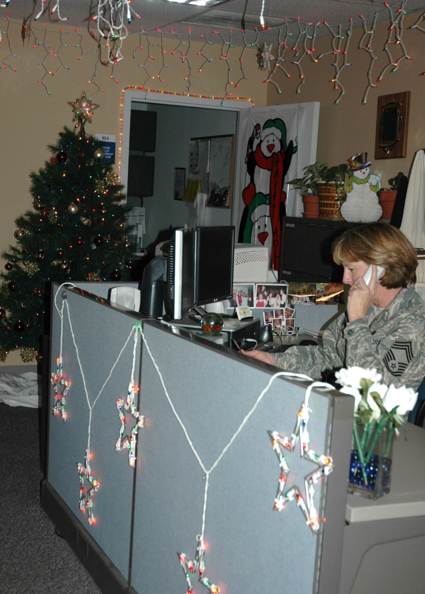 Surrounded by festive Christmas lights and decorations Chief Master Sgt. Maureen Adkins, 315th Communications Flight Chief, goes about her daily business, December 2, 2008.