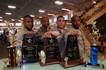 Randolph Braveheart football players (from left) Eric Doggett, Varnell Johnson, Joshua Fahlgren and Winsome Culley display their tropies at the fitness center Nov. 25. The Randolph-sponsored flag football team has won numerous trophies from tournaments in 2008 with most of the current, 18-man contingent together for more than three years. (U.S. Air Force photo by Rich McFadden)