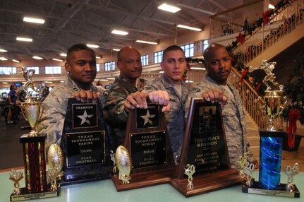 Randolph Braveheart football players (from left) Eric Doggett, Varnell Johnson, Joshua Fahlgren and Winsome Culley display their tropies at the fitness center Nov. 25. The Randolph-sponsored flag football team has won numerous trophies from tournaments in 2008 with most of the current, 18-man contingent together for more than three years. (U.S. Air Force photo by Rich McFadden)