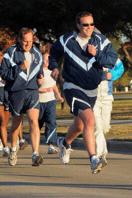 Capt. Adrian Patrascu (foreground) and Col. Jim Weimer run alongside Air Force Personnel Center Airmen at a unit run in honor of Warrior Care Month at Randolph Air Force Base, Texas, on Nov. 25, 2008. (Air Force photo by Melissa Peterson)