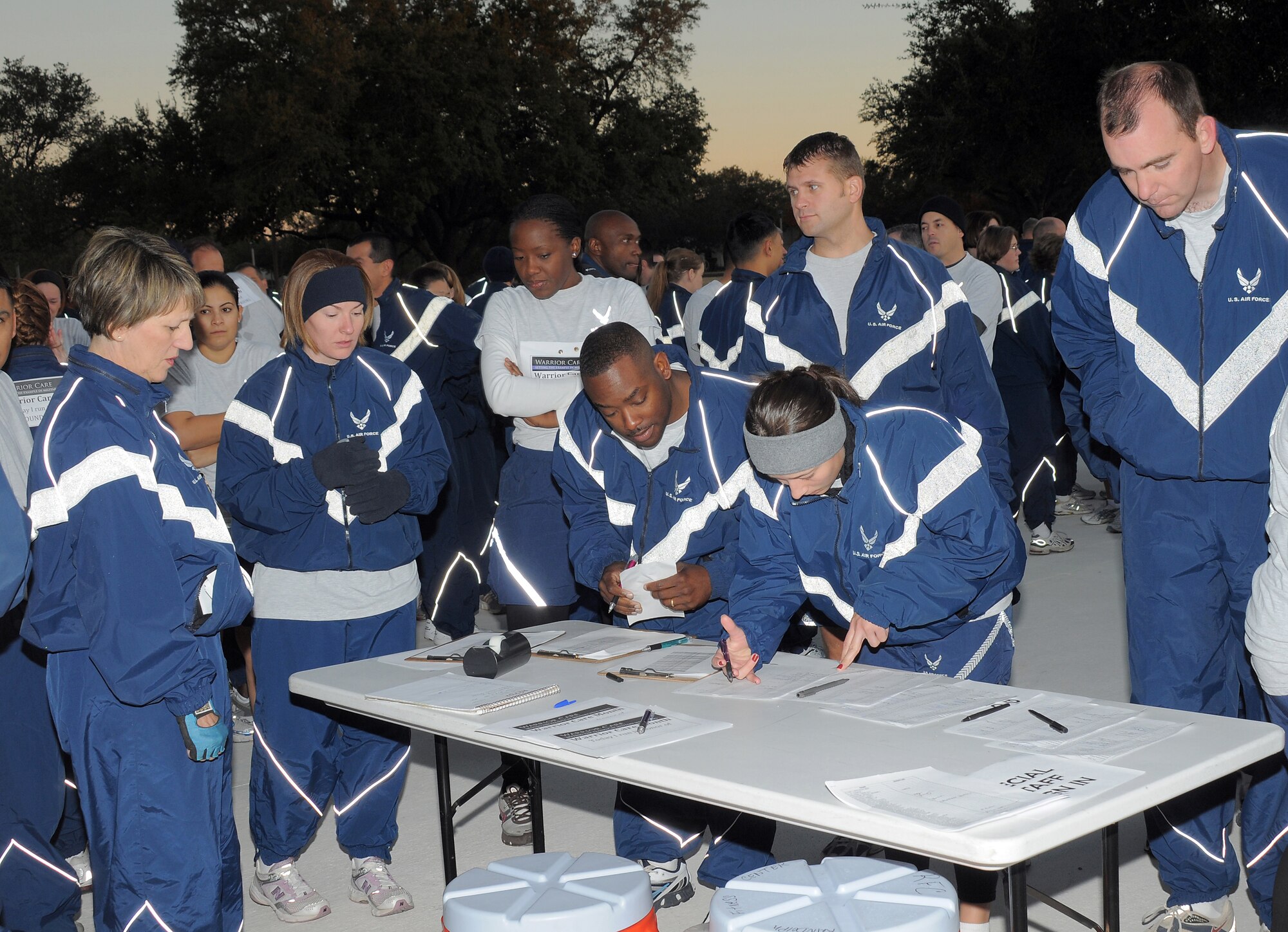 Maj. Gen. K.C. McClain, commander, Air Force Personnel Center, Randolph Air Force Base, Texas, watches as AFPC Airmen sign into a unit run held in honor or Warrior Care Month on Nov. 25, 2008. (Air Force photo by Melissa Peterson)