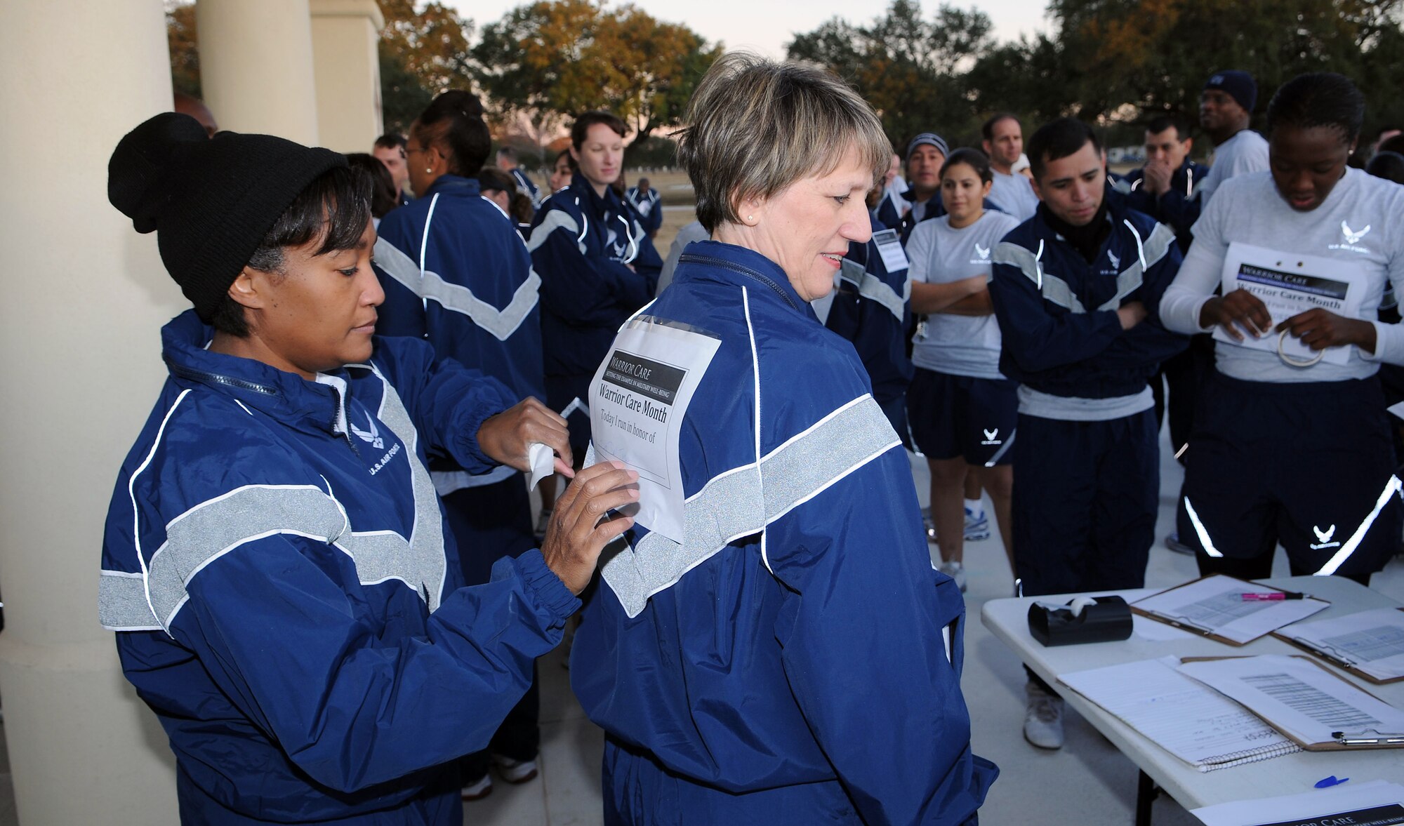 Lt. Col. Dawn Keasley, Air Force Personnel Center commander executive, pins a runner's bib on Maj. Gen. K.C. McClain, AFPC commander, before the Warrior Care Run at Randolph Air Force Base, Texas, on Nov. 25, 2008. (USAF Photo by Don Lindsey)