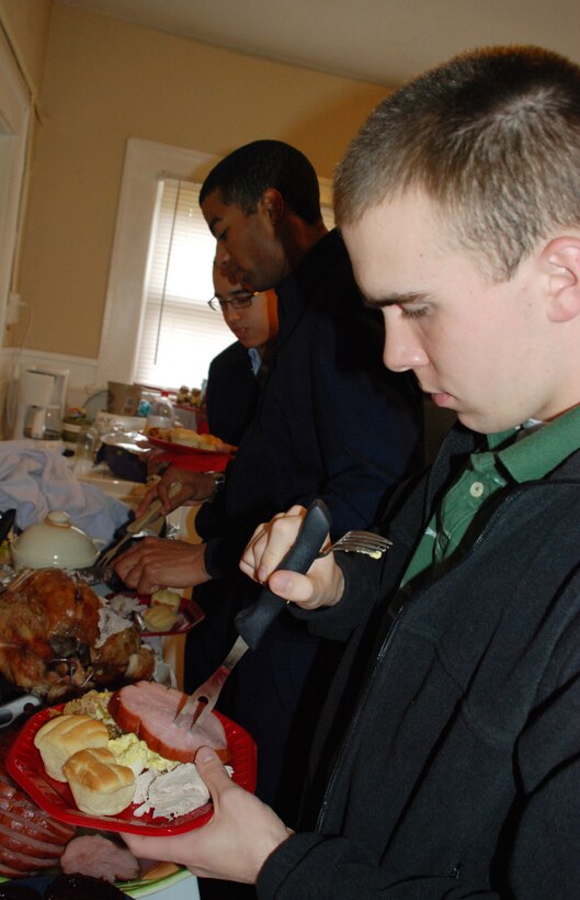 Airman 1st Class Patrick Jones, a non-prior service Airman of the 365th Training Squadeon, fills his plate during Operation Thanksgiving Nov. 27. Operation Thanksgiving provided 536 Airmen in Training the opportunity to get to know the community outside of Sheppard. (U.S. Air Force photo/Airman 1st Class Candy Miller) 