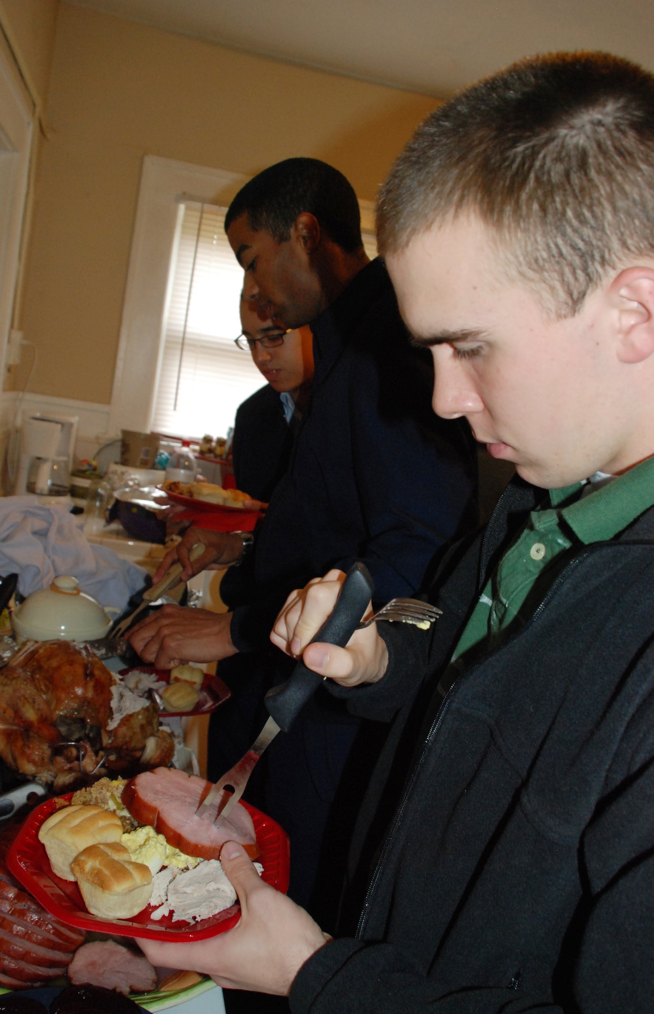 Airman 1st Class Patrick Jones, a non-prior service Airman of the 365th Training Squadeon, fills his plate during Operation Thanksgiving Nov. 27. Operation Thanksgiving provided 536 Airmen in Training the opportunity to get to know the community outside of Sheppard. (U.S. Air Force photo/Airman 1st Class Candy Miller) 