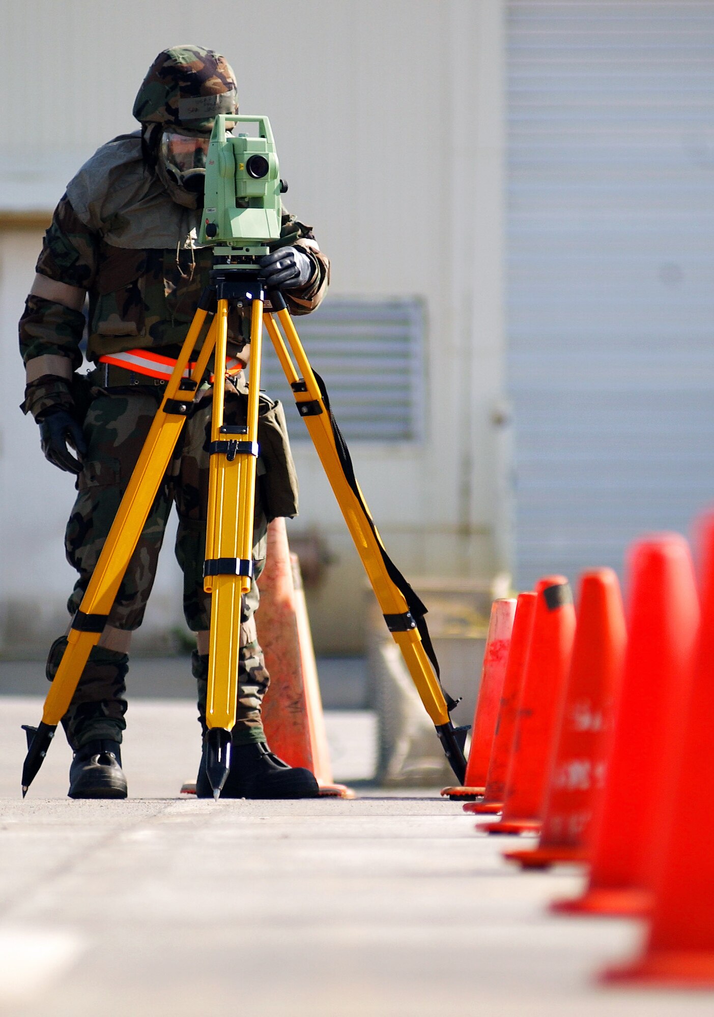 An Airman uses a theodo light to properly lay out papi lights for pilots to land safely during Silver Flag Nov. 24 at Kadena Air Base, Japan. During the exercise, which is run by Det. 1, 554th RED HORSE Squadron members, Airmen trained to establish and sustain a forward operating base in simulated wartime conditions. (U.S. Air Force photo/Tech. Sgt. Rey Ramon) 
                  